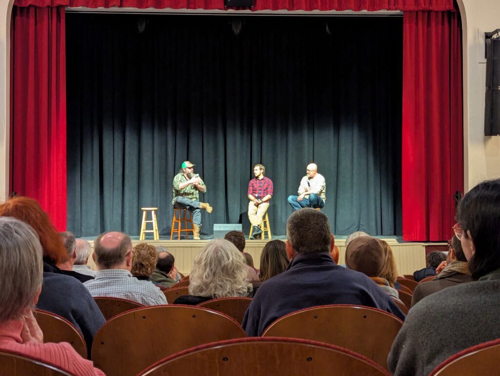 Mike McGraw, Santino, and Fran participate in a Q&A on stage after a Roots So Deep screening. 